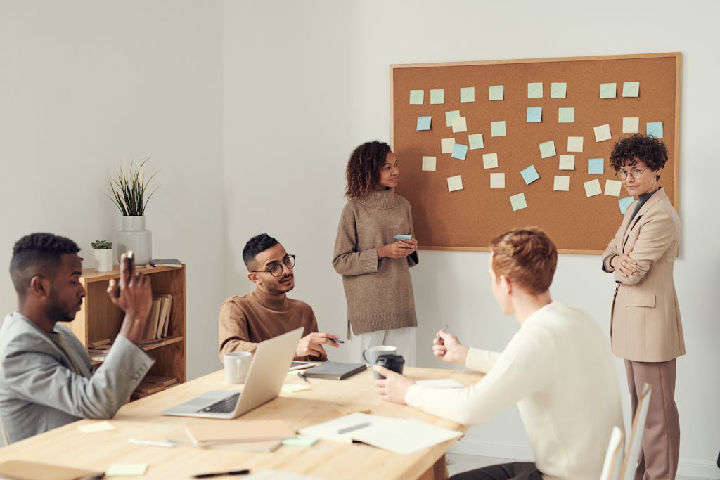 A diverse group of professionals collaborating in a modern office setting with a brainstorming session.