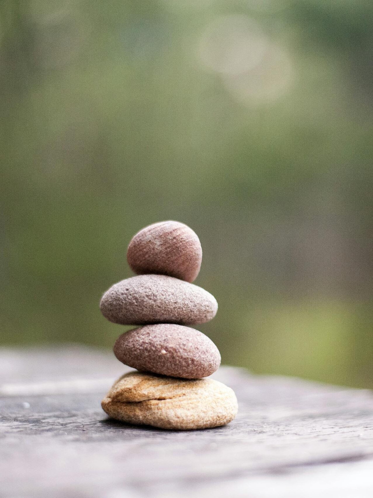 Balance and tranquility embodied by stacked stones in a natural outdoor setting.